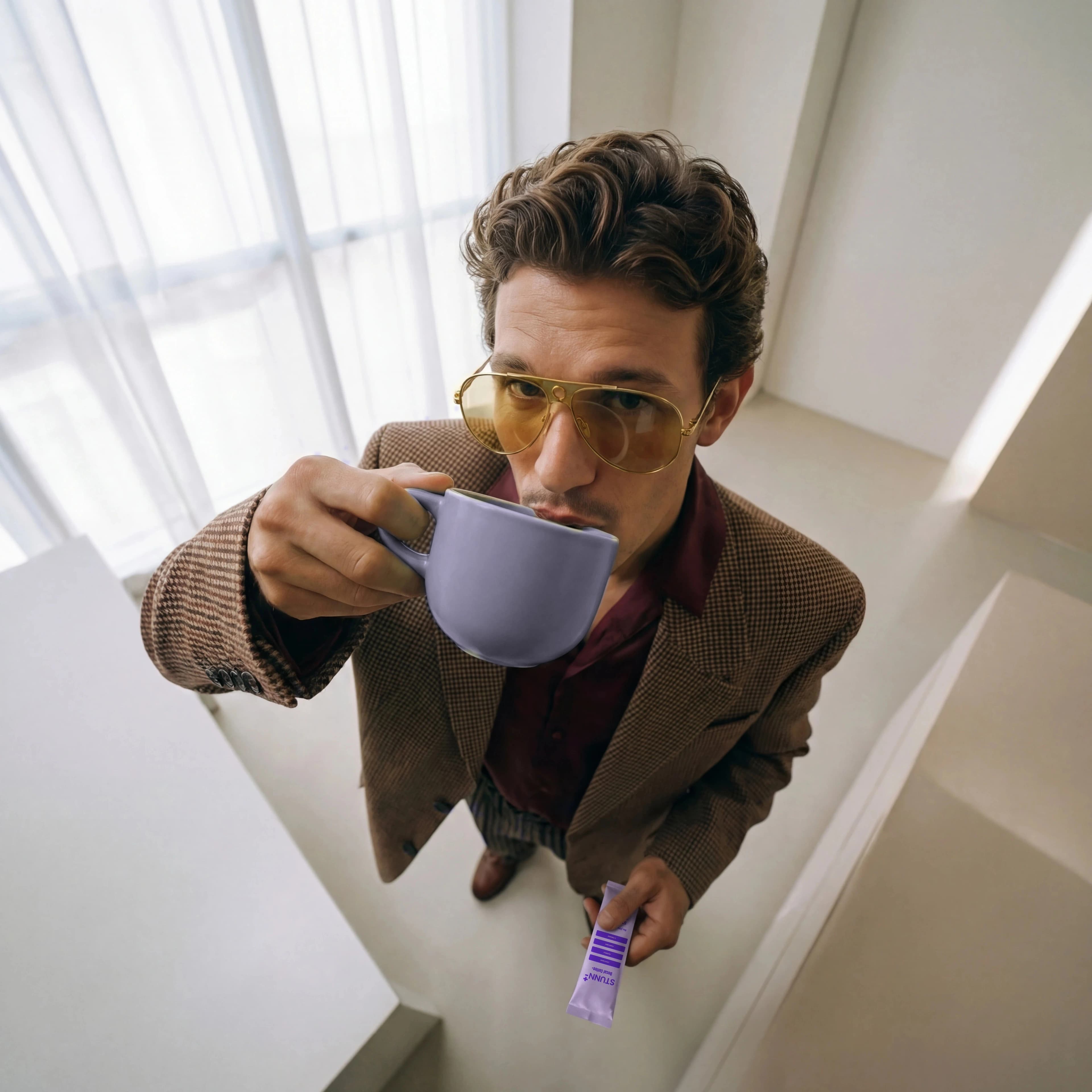 A man enjoying STUNN decaf coffee from a soft lavender mug